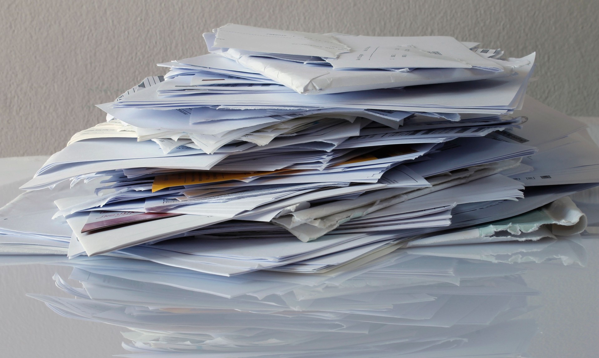 Piles of disorganized paperwork representing outdated financial records.